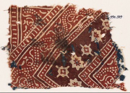 Textile fragment with stylized vine, rosettes, and diamond-shapesfront