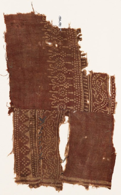 Textile fragment with dotted vines, possibly stylized columns, and poles with rosettesfront