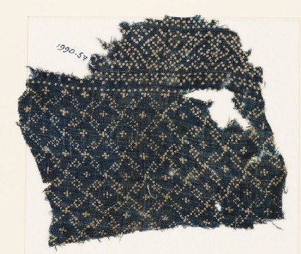 Textile fragment with rosettes and linked S-shapes made of dotsfront