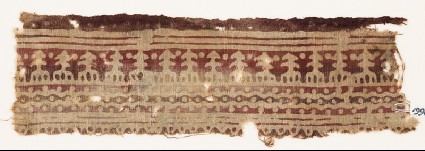 Textile fragment with wavy lines, dots, and possibly stylized treesfront