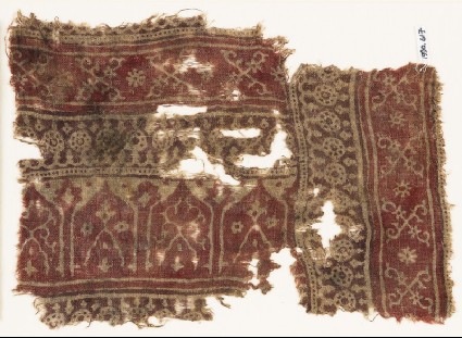 Textile fragment with bands of dotted circles, crossed tendrils, and archesfront