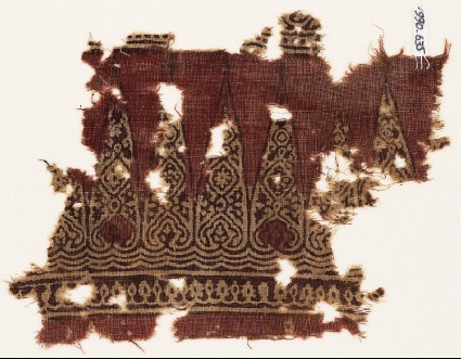 Textile fragment with cone-shapes and ornate floral designsfront