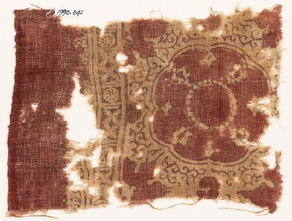 Textile fragment with large medallion, floral shapes, crosses, and circlesfront