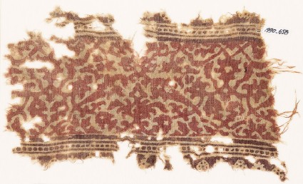 Textile fragment with interlacing vines, leaves, and flower-headsfront