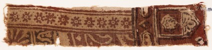 Textile fragment with rosettes, small cartouches, and a tab-shapefront