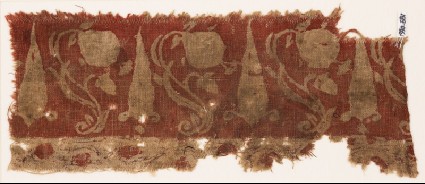 Textile fragment with large flowers, undulating stems, and possibly stylized leavesfront
