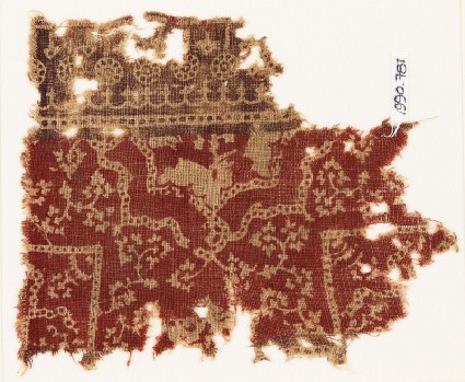 Textile fragment with half-medallion, parts of squares, and flowersfront