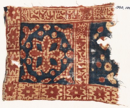 Textile fragment with square, a flower, stars, and Arabic inscriptionfront