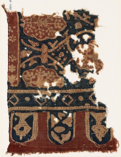Textile fragment with linked tendrils, stylized trees, and tabsfront