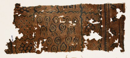 Textile fragment with stylized plants and tendrilsfront