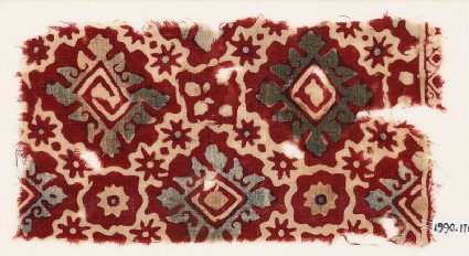 Textile fragment with ornate squares, stars, and flowersfront