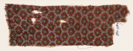 Textile fragment with grid of oval shapes and rosettesfront