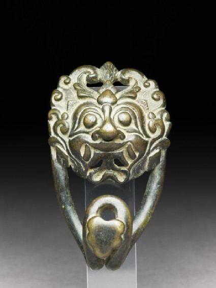 Bronze belt clasp with demon facefront
