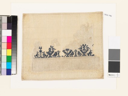 Textile fragment with stylized pairs of birds and treesfront