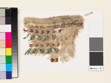 Textile fragment with chevrons and a floral scrolled stemfront