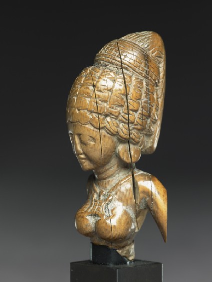 Female figure with a tall headressside