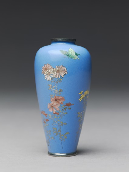 Vase with chrysanthemums and a butterflyside