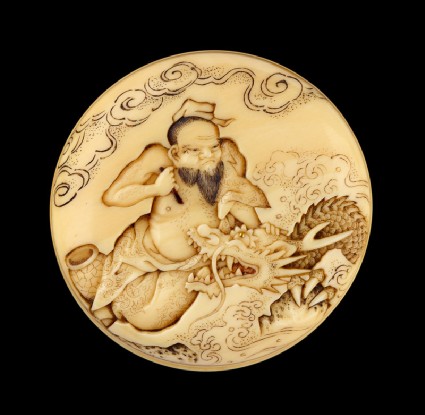 Manjū netsuke depicting the Daoist immortal Bashikō performing acupuncture on a dragonfront