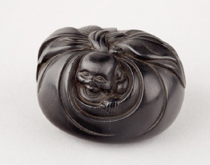Manjū netsuke in the form of Hotei peering from his sackoblique