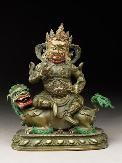 Figure of a male deity seated on a mythical animal, possibly a lion dogfront