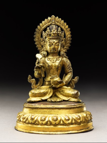 Seated figure of a deity holding a spoon and potfront