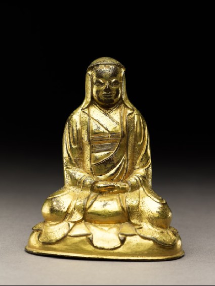 Seated figure of a monk with a robe draped over his headfront