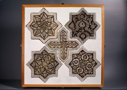Set of five tiles in the shapes of stars and a crossfront