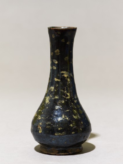 Black ware vase with yellow splashesside