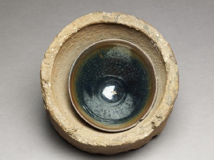 Black ware tea bowl stuck in its firing saggartop