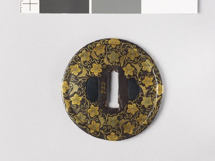 Round tsuba with karakusa, or scrolling floral patternfront