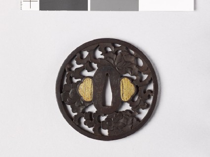 Round tsuba with peonies and a karakusa, or scrolling plant patternfront