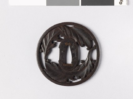 Round tsuba with oak leaves and dew dropsfront