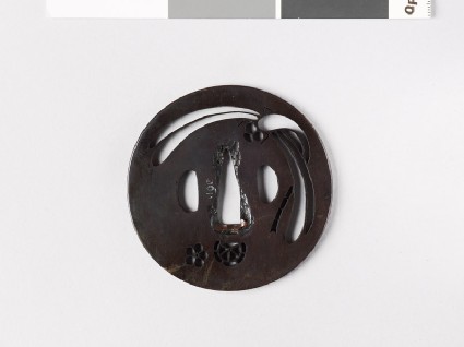 Round tsuba with mon formed from clematis flower and chariot wheelfront