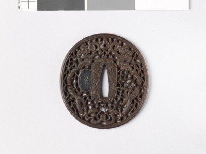 Tsuba with dragons and karakusa, or scrolling plant patternfront