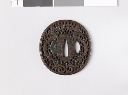 Tsuba with dragons and karakusa, or scrolling plant patternfront
