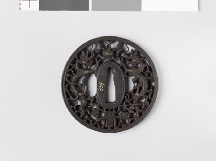 Tsuba with dragons and pearls amid karakusa, or scrolling plant patternfront