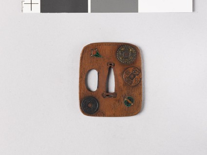 Aori-shaped tsuba depicting charms, coins, and three of the Seven Treasuresfront