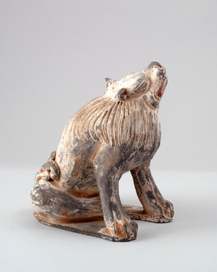 Figure of a lion scratching its headfront
