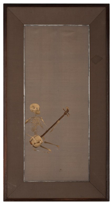 Skeleton kneeling playing a shamisen, or plucked instrumentfront, Cat. No. 38