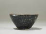 Black ware tea bowl with 'tortoiseshell' glazes (side)