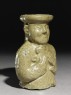 Greenware burial vessel section in the form of man holding a goat (oblique)