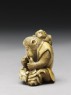 Netsuke in the form of a monkey holding a crab (side)