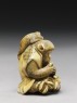 Netsuke in the form of a monkey holding a crab (side)