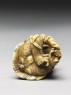 Netsuke in the form of a monkey holding a crab (bottom)