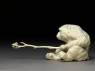 Okimono, or ornament, in the form of a monkey holding a branch (side)