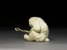 Okimono, or ornament, in the form of a monkey holding a branch (side)