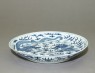 Blue-and-white dish with dragons chasing a flaming pearl (oblique)