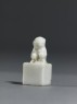 Porcelain seal surmounted by a seated animal (side)