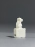 Porcelain seal surmounted by a seated animal (side)