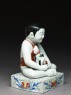 Figure of a boy seated on a shogi, or chess board (side)